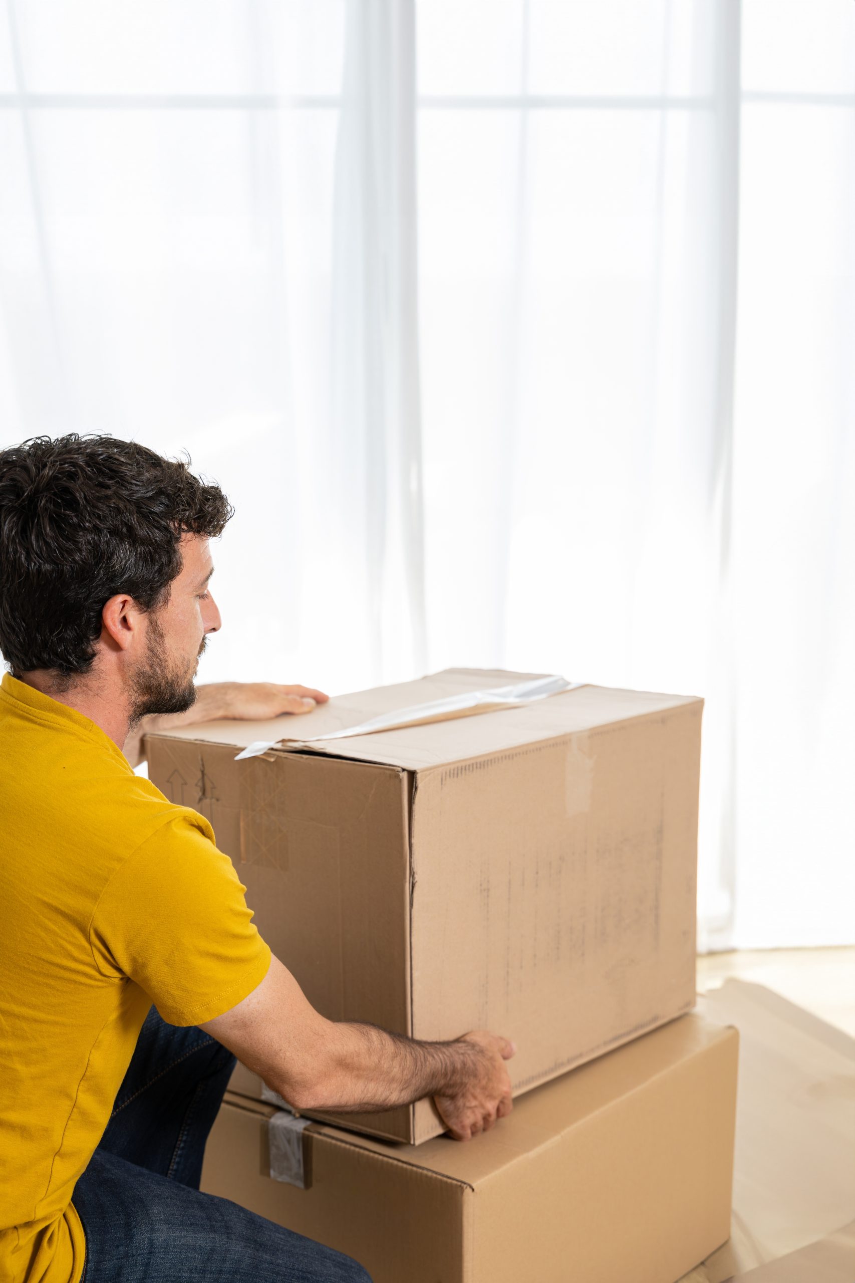 Young,Man,Moving,To,New,Apartment.,Moving,,People,And,Real