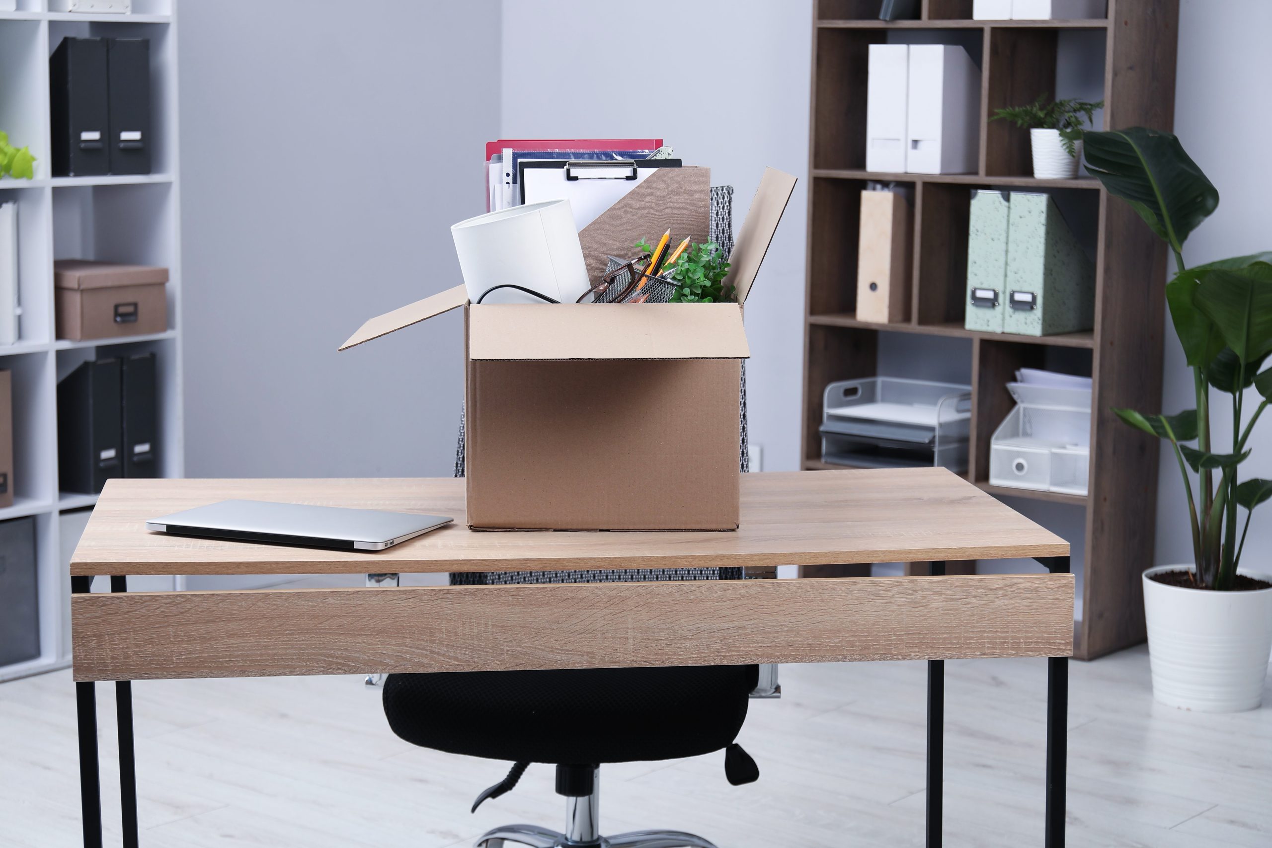 Dismissal.,Box,Of,Personal,Belongings,On,Desk,In,Office